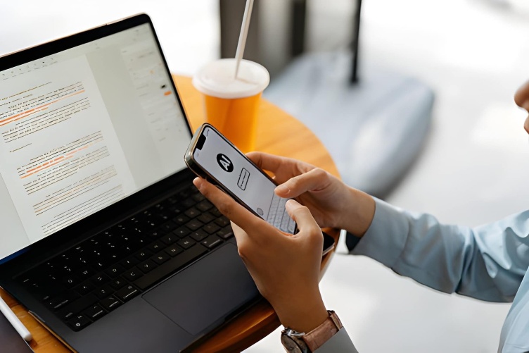 A student working on a laptop with AI tools